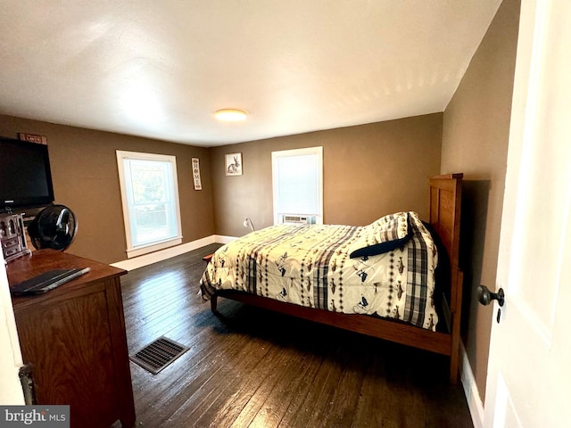 bedroom with dark wood-type flooring