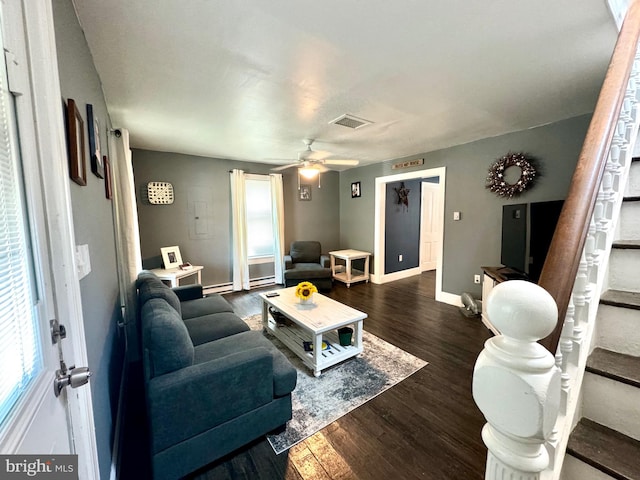 living room featuring ceiling fan and dark hardwood / wood-style floors