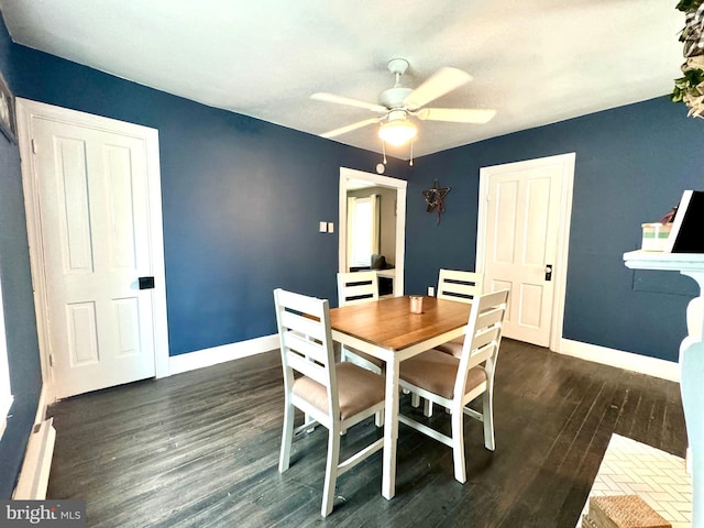 dining area with dark hardwood / wood-style flooring and ceiling fan