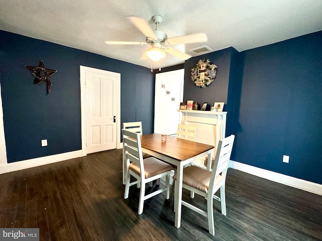 dining room with dark hardwood / wood-style flooring and ceiling fan