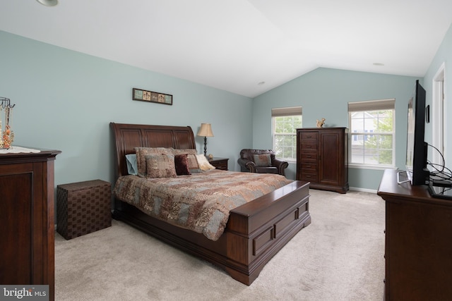 bedroom featuring vaulted ceiling and light colored carpet