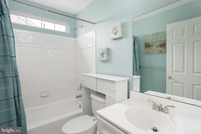 full bathroom featuring vanity, shower / bath combo with shower curtain, and toilet