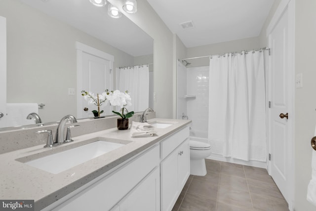 full bathroom featuring vanity, toilet, shower / bathtub combination with curtain, and tile patterned flooring