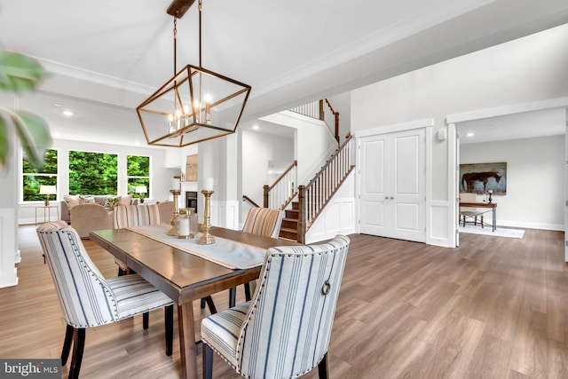 dining room featuring wood-type flooring and an inviting chandelier