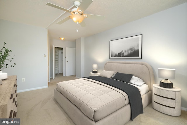 bedroom featuring light carpet, ceiling fan, and baseboards