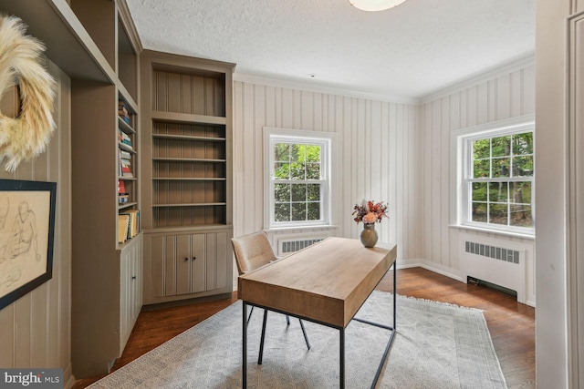 office space with radiator heating unit, a wealth of natural light, and dark wood-type flooring