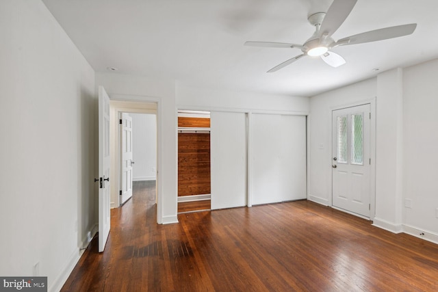 unfurnished bedroom featuring dark hardwood / wood-style flooring and ceiling fan