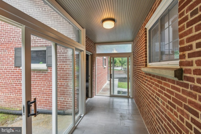 unfurnished sunroom featuring wooden ceiling