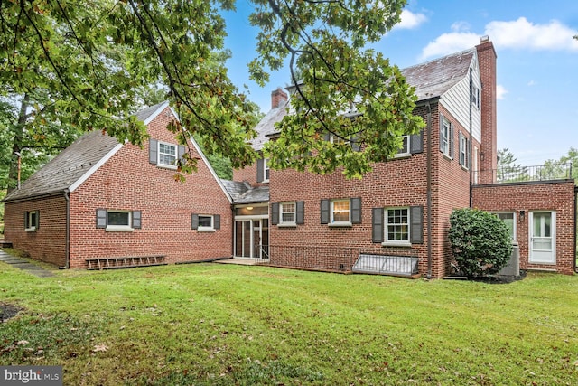 back of house with a lawn