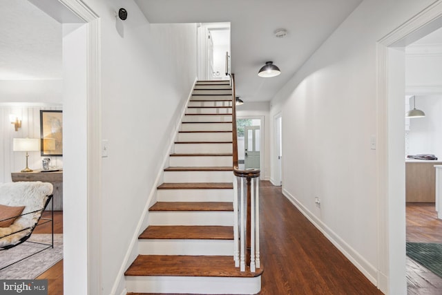 stairs with hardwood / wood-style floors