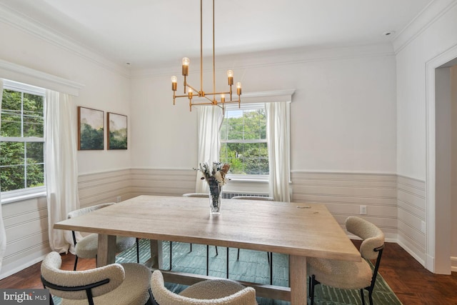 dining space featuring a notable chandelier, crown molding, and a healthy amount of sunlight