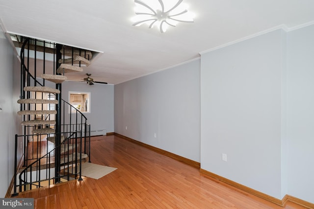 spare room featuring hardwood / wood-style flooring, ornamental molding, and ceiling fan