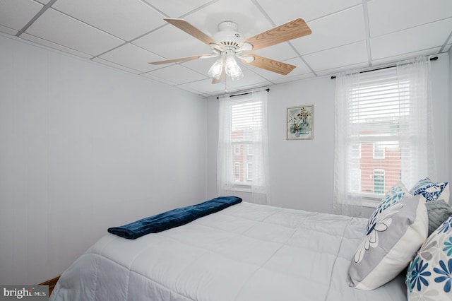 bedroom with ceiling fan and a paneled ceiling