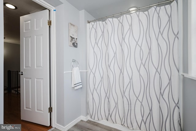 bathroom with wood-type flooring