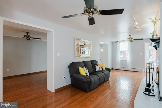 living room with hardwood / wood-style flooring and a baseboard radiator