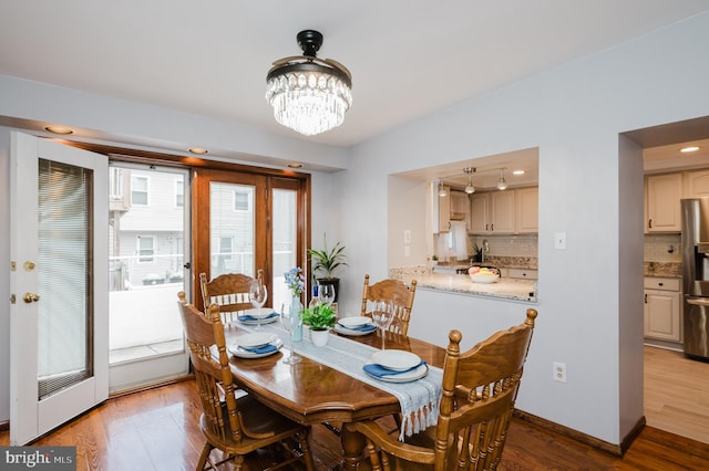 dining room with a chandelier and light wood-type flooring