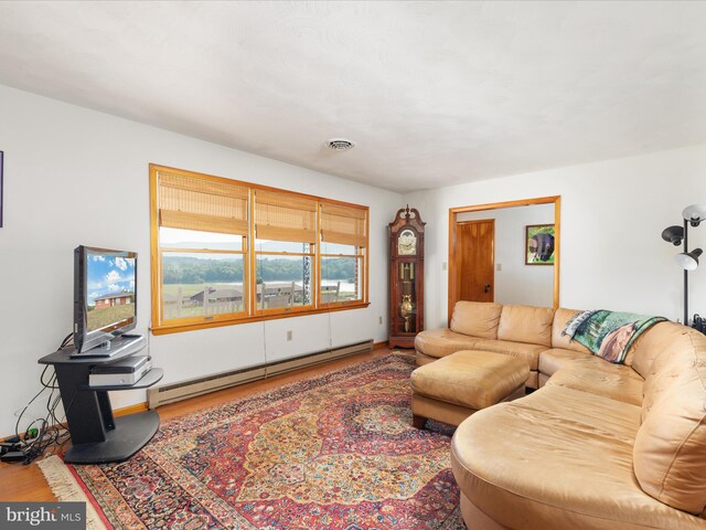 living room featuring light hardwood / wood-style flooring and ceiling fan