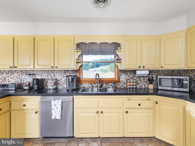 kitchen with sink, backsplash, and appliances with stainless steel finishes