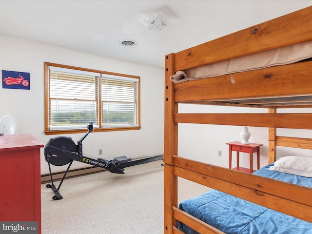 carpeted bedroom with a baseboard heating unit