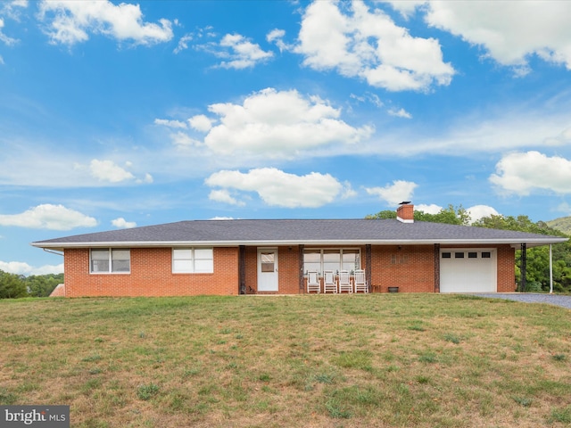 ranch-style home with a garage and a front yard