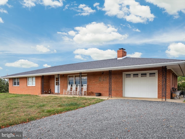 ranch-style home featuring a garage, a front lawn, and covered porch