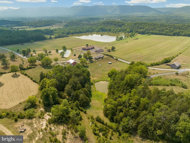 drone / aerial view featuring a water and mountain view and a rural view