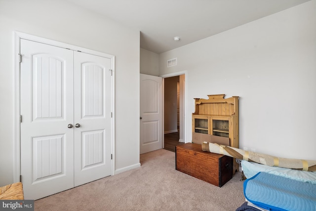 carpeted bedroom featuring a closet