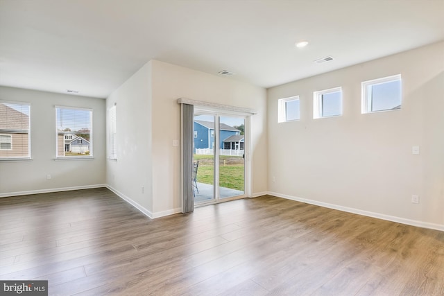 spare room featuring wood-type flooring