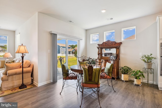 dining space featuring plenty of natural light and dark hardwood / wood-style flooring