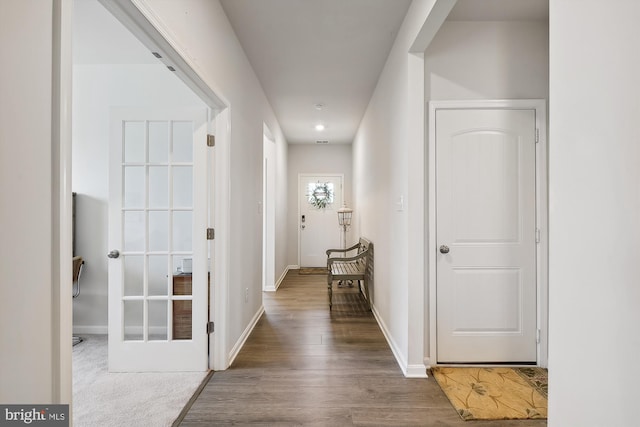 hall with hardwood / wood-style floors