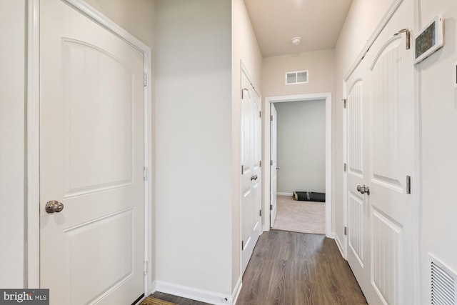 hallway with dark hardwood / wood-style flooring