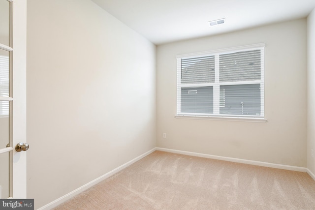 carpeted spare room with a wealth of natural light