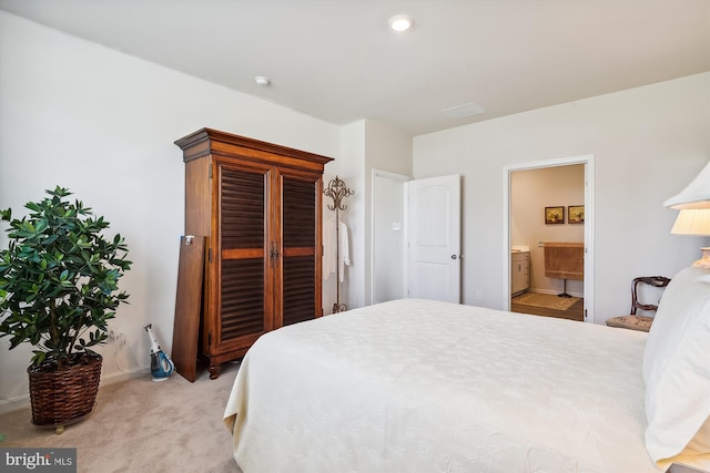 carpeted bedroom featuring ensuite bathroom