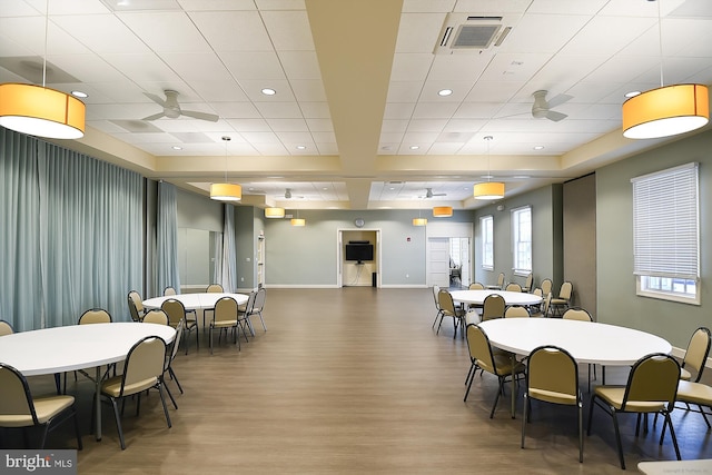 dining area with ceiling fan and wood-type flooring