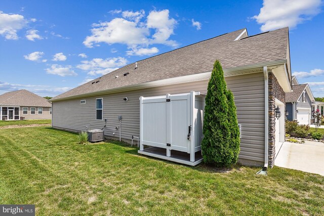 craftsman-style home with central AC unit and a garage