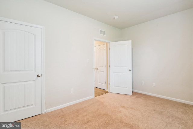 unfurnished bedroom with light carpet