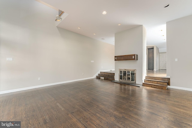 unfurnished living room with dark hardwood / wood-style floors