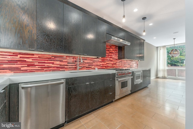 kitchen featuring decorative backsplash, appliances with stainless steel finishes, light tile patterned floors, decorative light fixtures, and sink