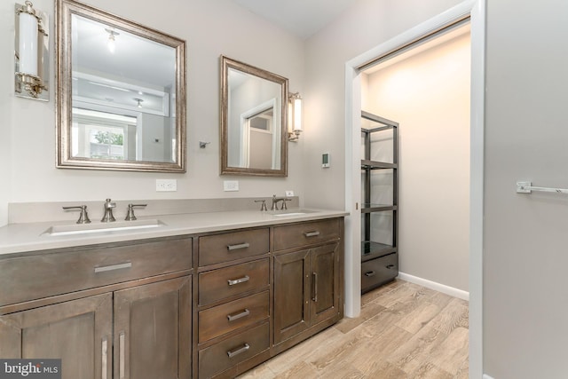 bathroom with double vanity and hardwood / wood-style flooring