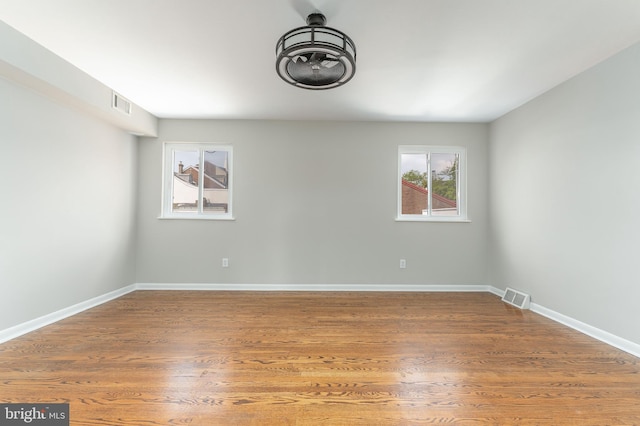 unfurnished room with wood-type flooring