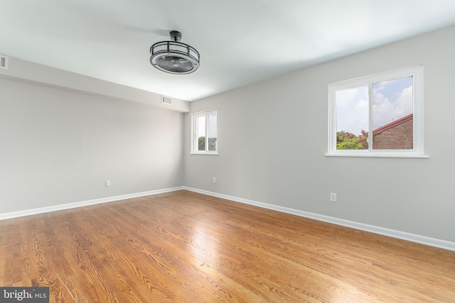 unfurnished room with hardwood / wood-style floors