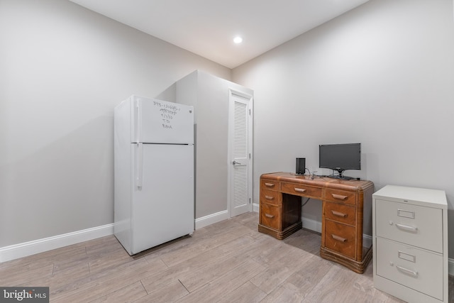 office with light wood-type flooring