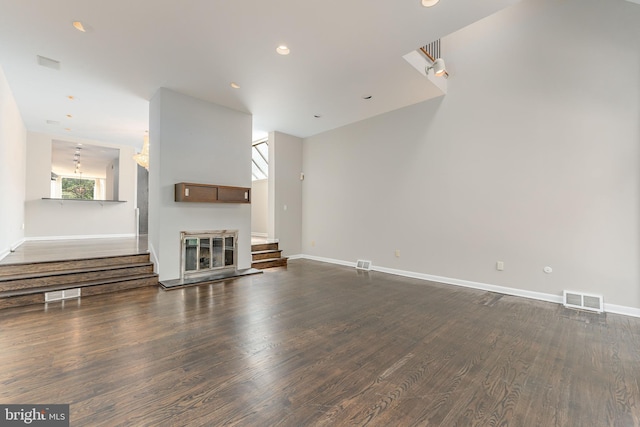 unfurnished living room featuring dark hardwood / wood-style flooring