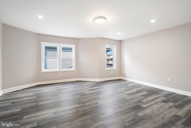 unfurnished room with recessed lighting, baseboards, and dark wood-style flooring