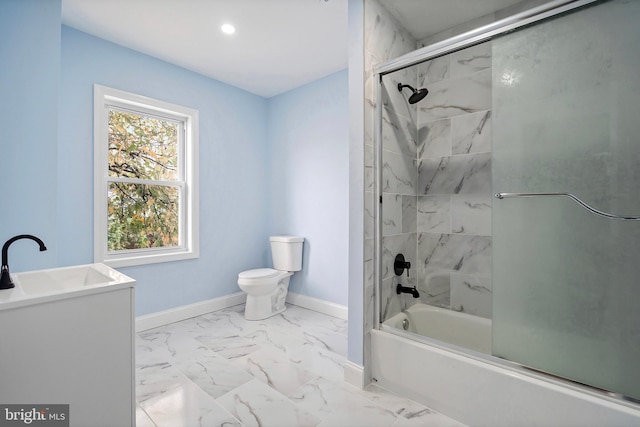 full bathroom featuring toilet, marble finish floor, a sink, baseboards, and enclosed tub / shower combo