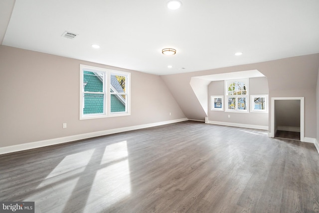 bonus room with visible vents, baseboards, lofted ceiling, recessed lighting, and wood finished floors