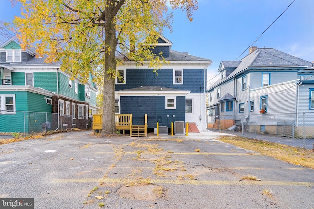 back of property featuring fence, central AC, and a wooden deck