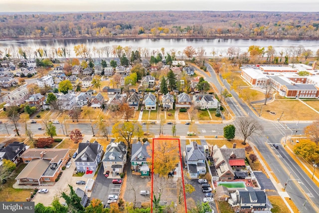 birds eye view of property featuring a residential view, a wooded view, and a water view