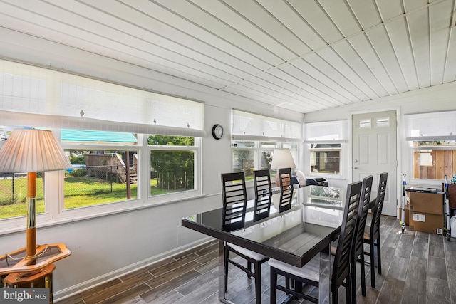 dining area with dark hardwood / wood-style flooring and vaulted ceiling