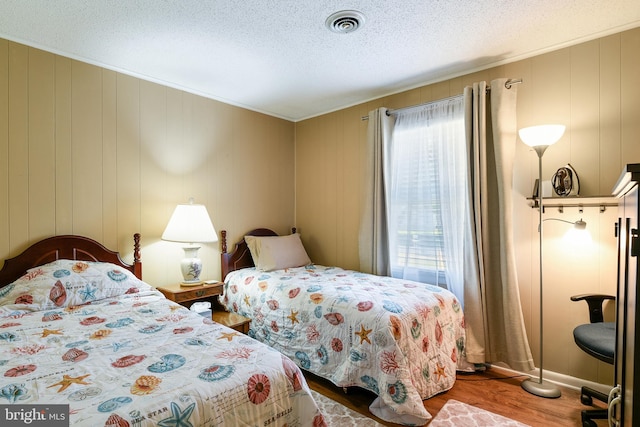 bedroom featuring a textured ceiling and hardwood / wood-style flooring